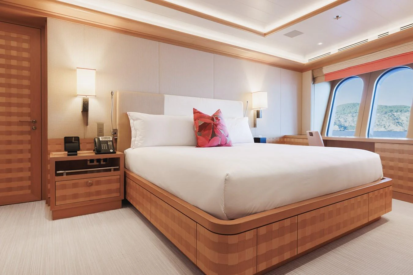 a bed with a pink pillow aboard ROCINANTE Yacht for Sale