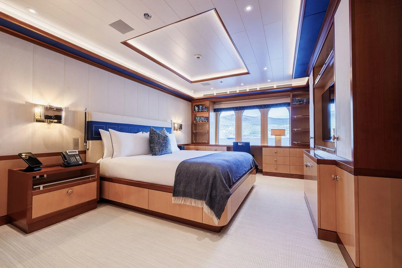 a bedroom with a bed and a desk aboard ROCINANTE Yacht for Sale