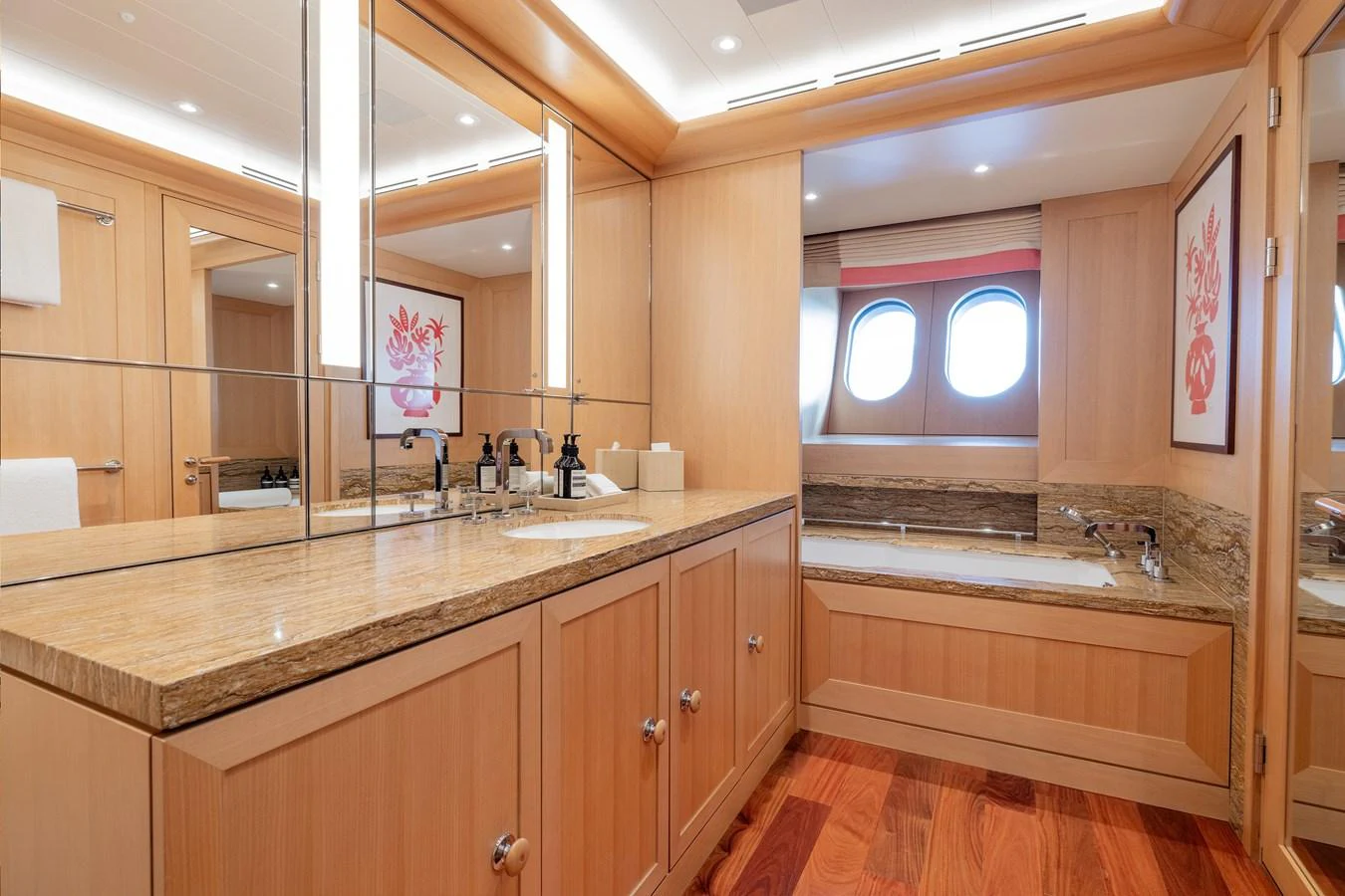 a large bathroom with a large mirror aboard ROCINANTE Yacht for Sale