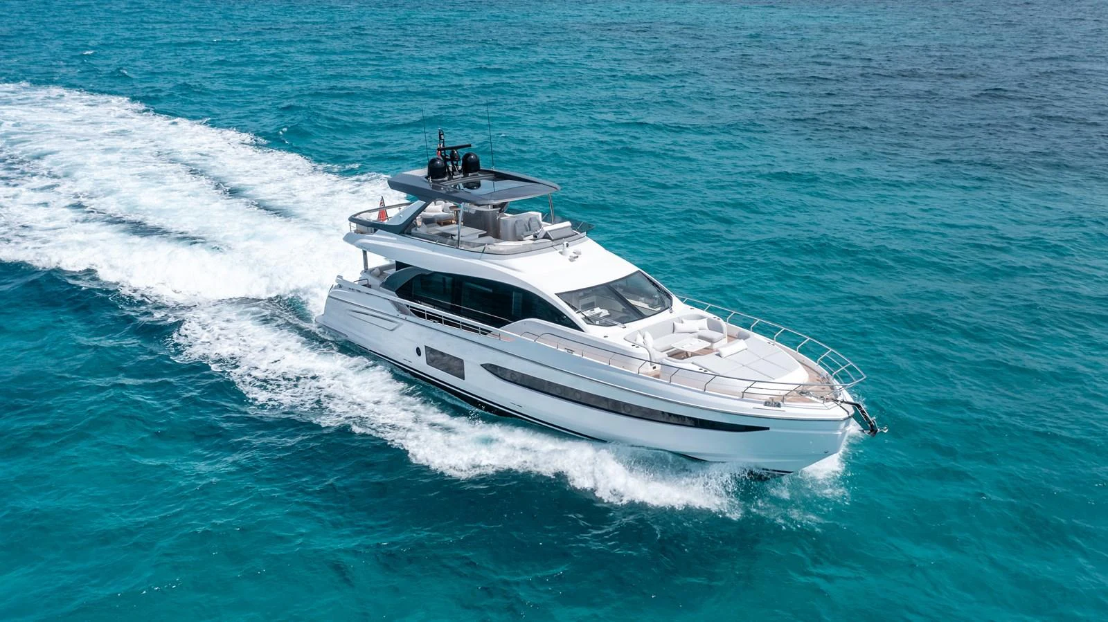 A sleek and modern yacht cruising through clear blue waters, showcasing its elegant design and powerful performance. aboard EUPHORIA Yacht for Sale