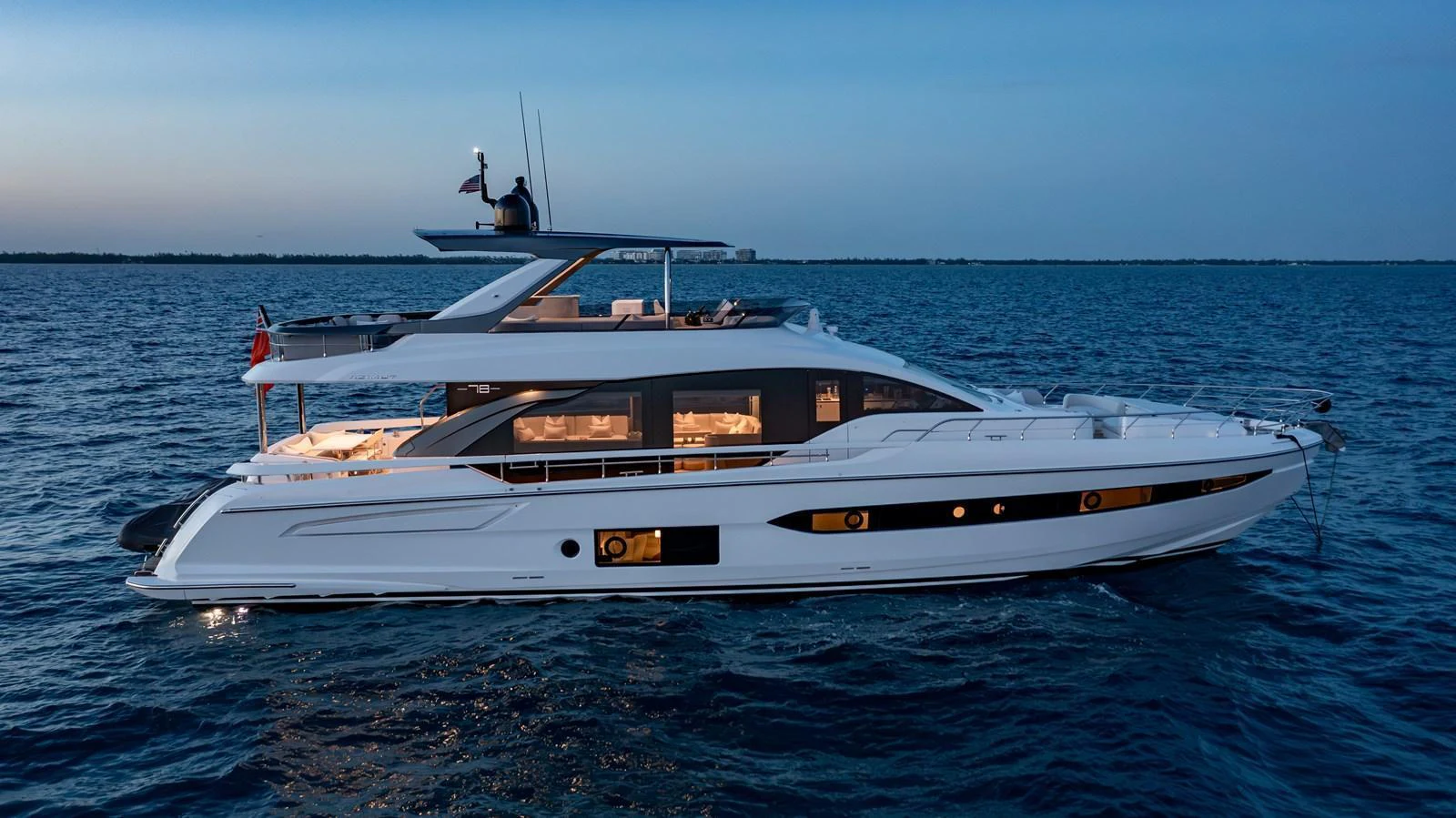 A sleek and modern yacht cruising on calm waters at dusk. aboard EUPHORIA Yacht for Sale