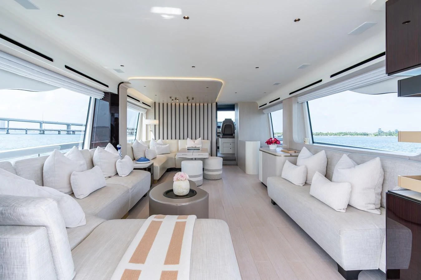 The spacious salon features elegant seating with panoramic views through large windows. aboard EUPHORIA Yacht for Sale