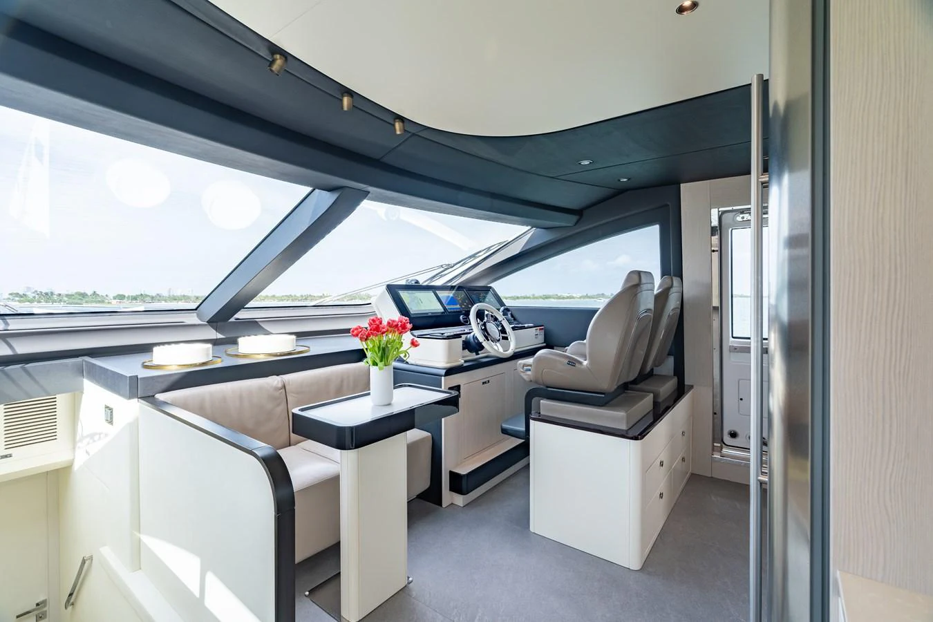 The helm area features modern seating and a sleek control panel with panoramic windows offering expansive views. aboard EUPHORIA Yacht for Sale