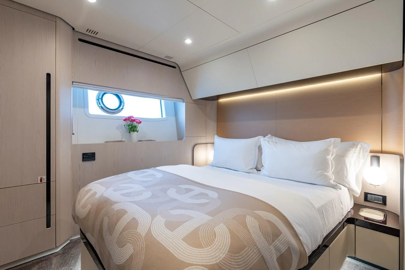 A luxurious stateroom featuring a plush bed with elegant linens and modern lighting. aboard EUPHORIA Yacht for Sale