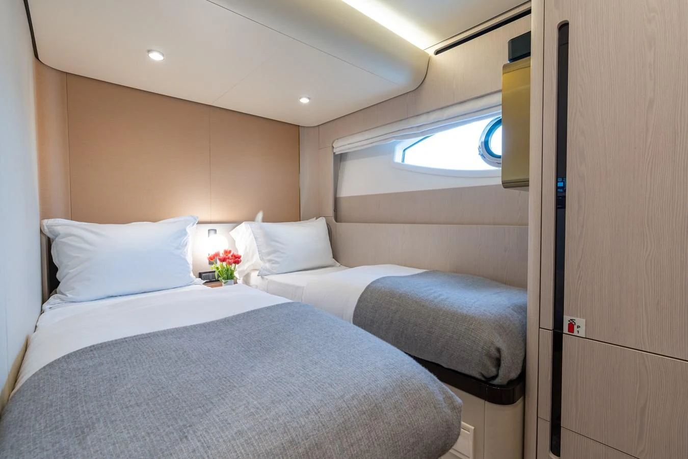 A cozy twin stateroom with modern decor and soft lighting. aboard EUPHORIA Yacht for Sale