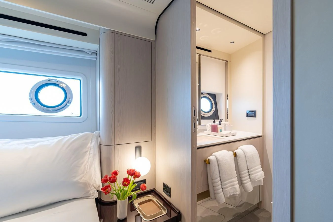 A cozy guest stateroom featuring a comfortable bed and an en-suite bathroom with modern amenities. aboard EUPHORIA Yacht for Sale