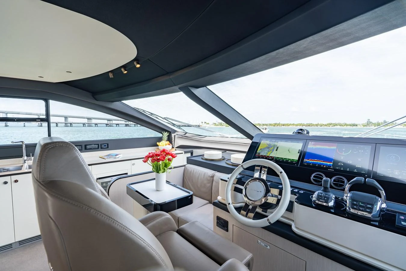 The helm station features modern navigation equipment and luxurious seating with a panoramic view. aboard EUPHORIA Yacht for Sale