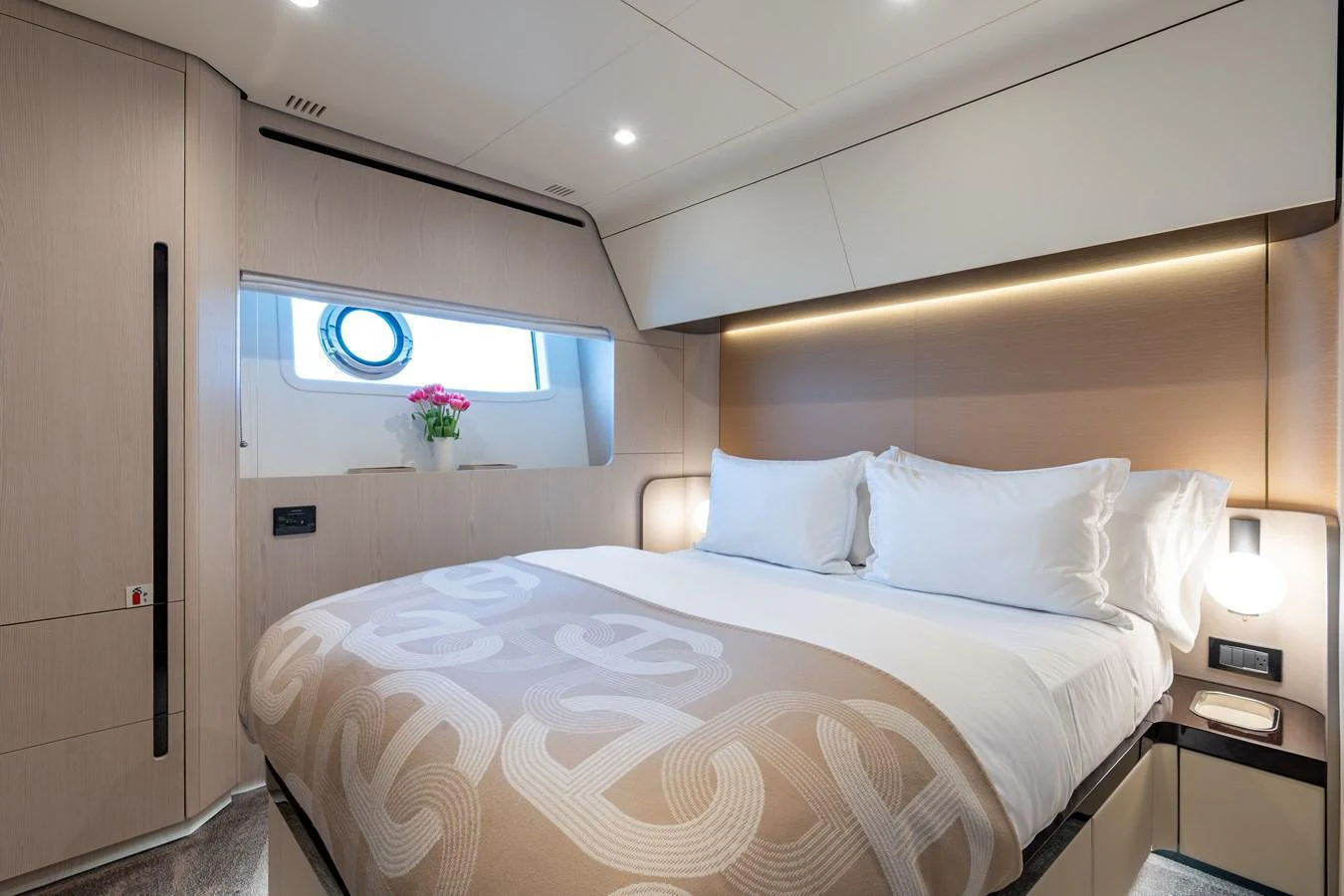The stateroom features a plush bed with elegant bedding and a window providing natural light. aboard EUPHORIA Yacht for Sale