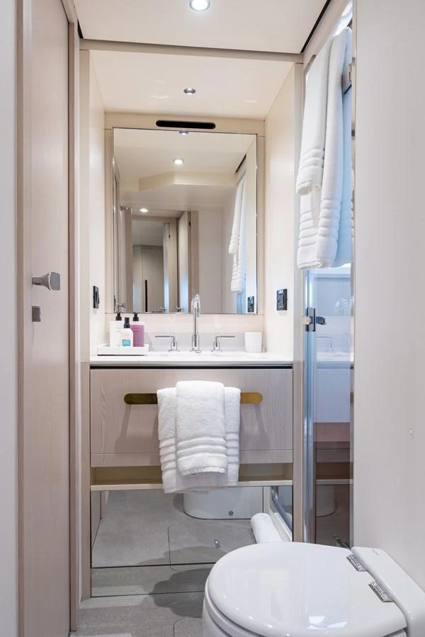 A sleek and modern yacht bathroom with elegant fixtures and ample lighting. aboard EUPHORIA Yacht for Sale