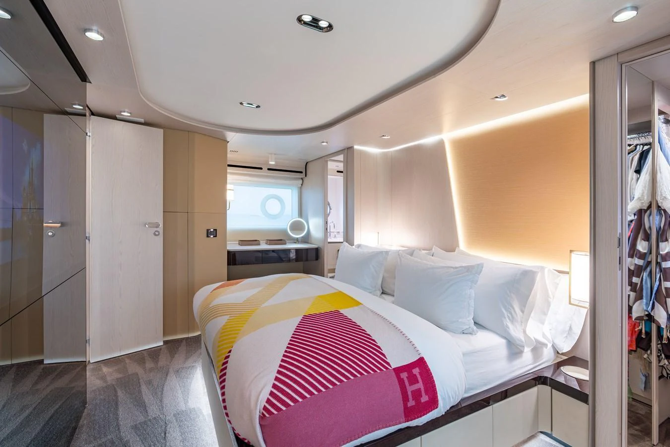 The stateroom features a luxurious bed with plush pillows and modern lighting. aboard EUPHORIA Yacht for Sale