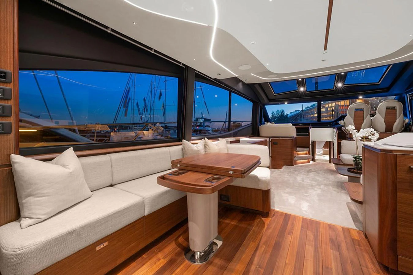 The salon features elegant wood finishes, plush seating, and large windows offering panoramic views. aboard PRINCESS S72 Yacht for Sale