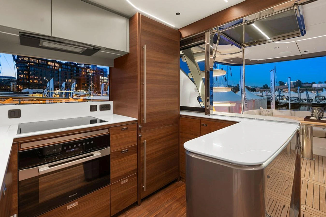 The modern galley features sleek wooden cabinetry and state-of-the-art appliances, seamlessly blending into the yacht's luxurious design. aboard PRINCESS S72 Yacht for Sale