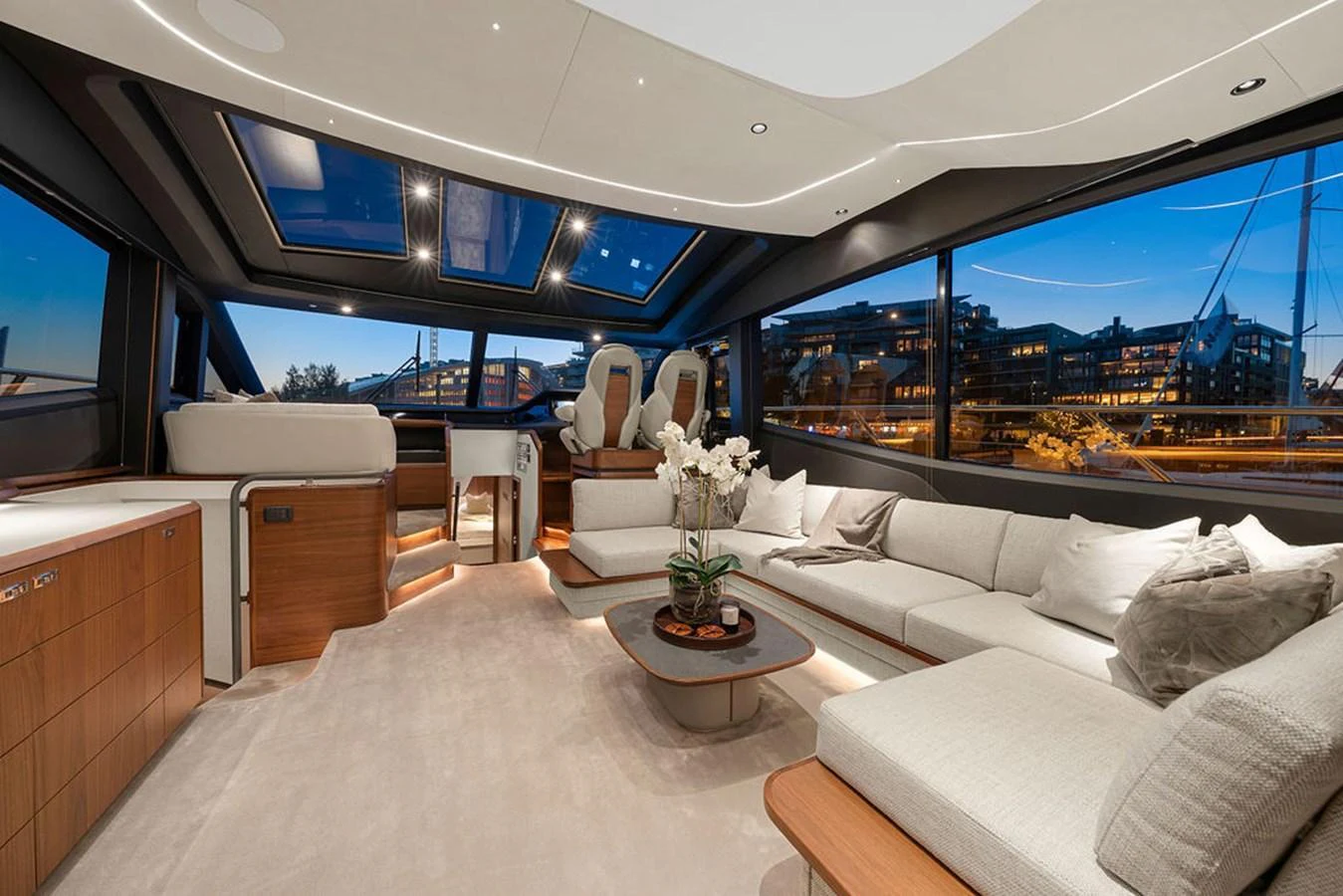 The salon features a spacious and luxurious seating area with panoramic windows offering stunning views. aboard PRINCESS S72 Yacht for Sale