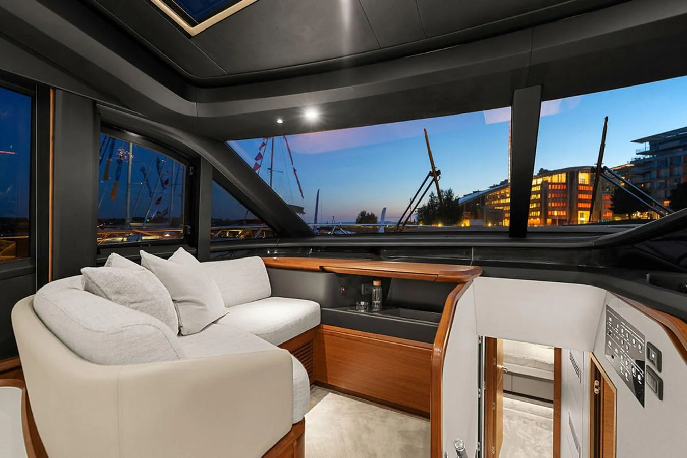 The yacht's salon offers a cozy seating area with panoramic views through large windows. aboard PRINCESS S72 Yacht for Sale