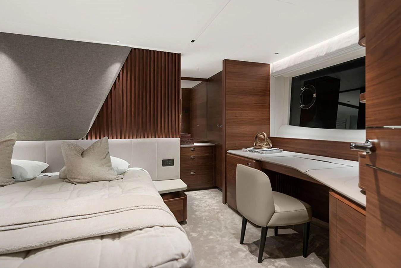 The stateroom features elegant wood paneling, a plush bed, and a functional desk area. aboard PRINCESS S72 Yacht for Sale
