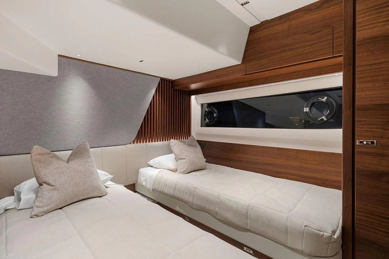 The twin stateroom offers a cozy and modern retreat with two single beds and elegant wood paneling. aboard PRINCESS S72 Yacht for Sale