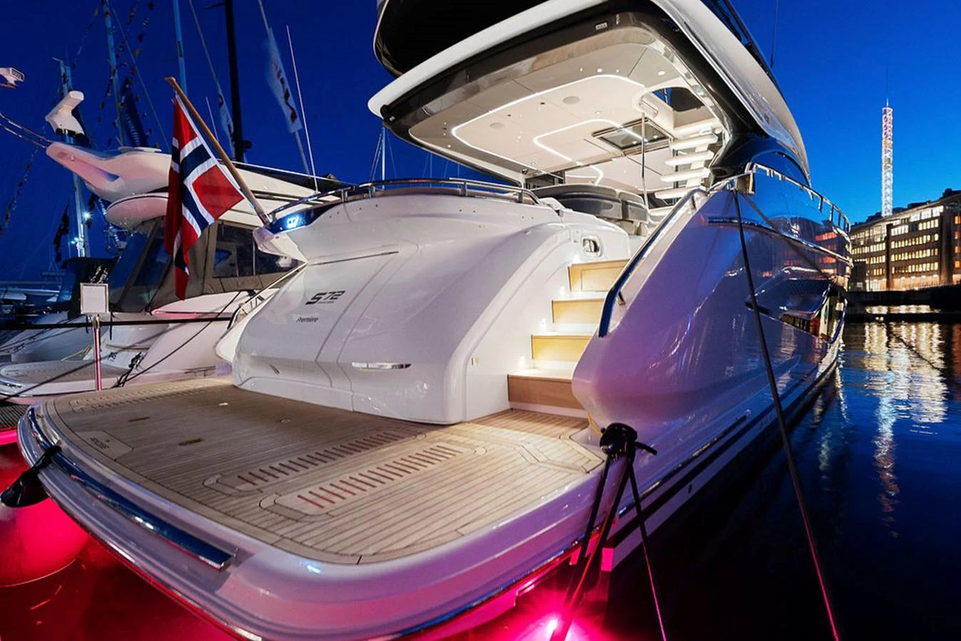 The yacht's aft deck is beautifully illuminated, showcasing its elegant design and spacious layout. aboard PRINCESS S72 Yacht for Sale