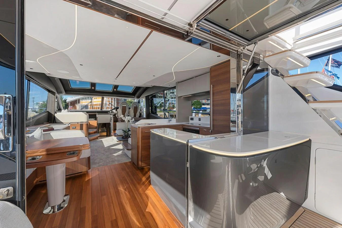 The yacht's salon features modern furnishings, ample natural light, and elegant wood finishes. aboard PRINCESS S72 Yacht for Sale