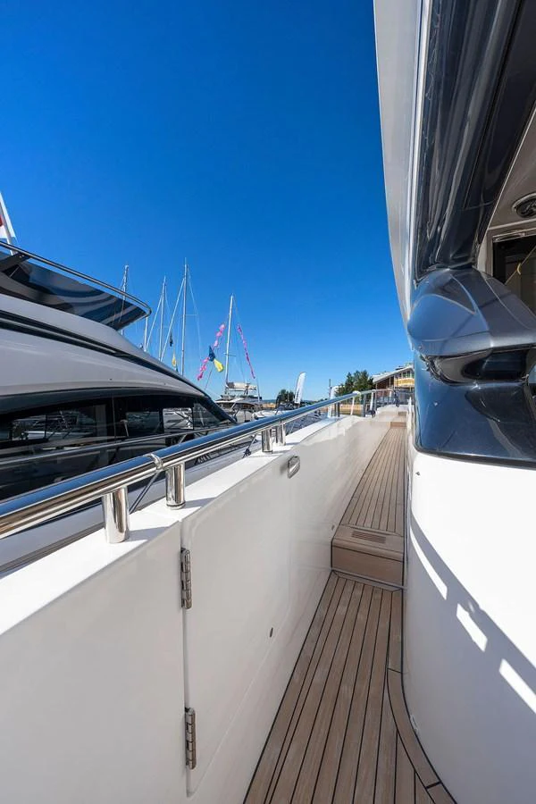 The sleek side deck of the yacht offers a glimpse of its modern design and craftsmanship. aboard PRINCESS S72 Yacht for Sale