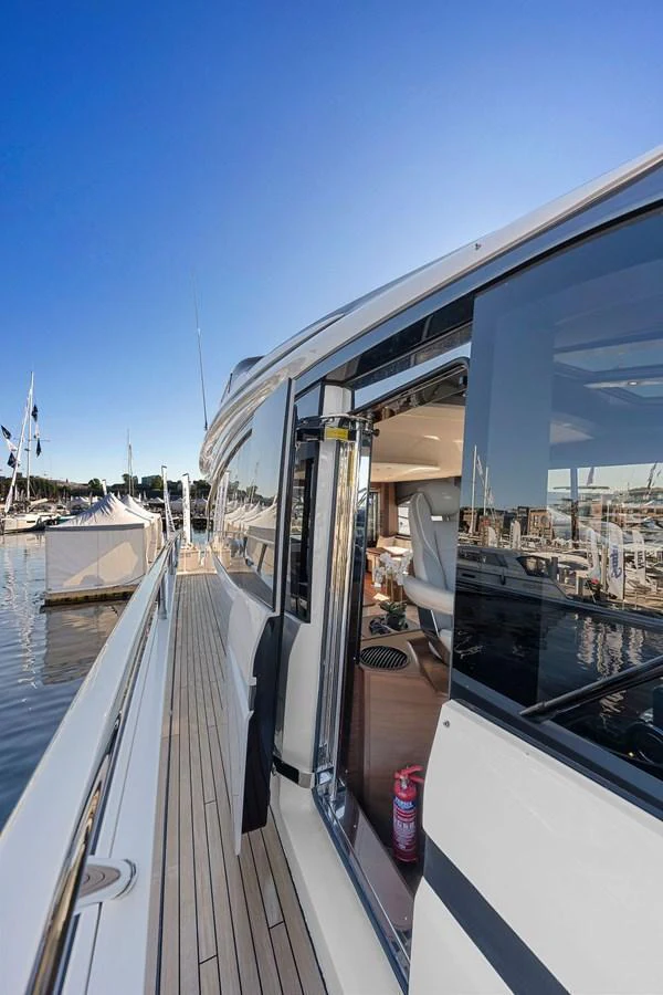 The side deck of the yacht offers a glimpse into the luxurious interior through a sliding glass door. aboard PRINCESS S72 Yacht for Sale