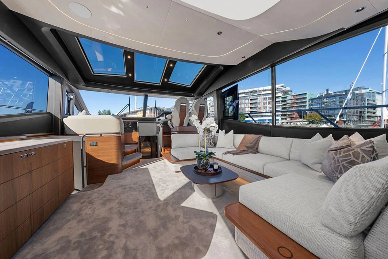 The salon features plush seating, a modern entertainment system, and expansive windows offering panoramic views. aboard PRINCESS S72 Yacht for Sale