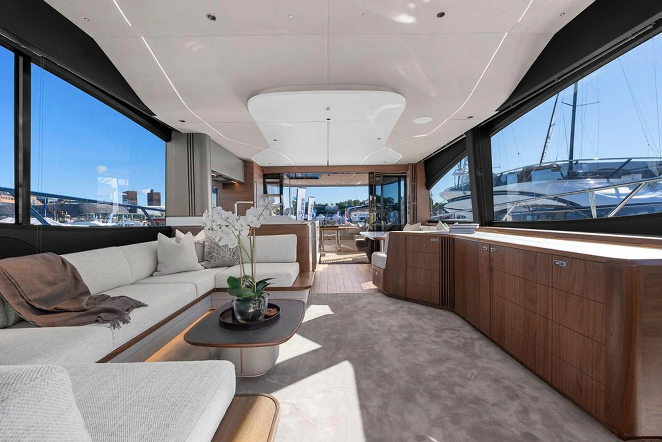 The spacious salon features elegant furnishings and large windows offering panoramic views. aboard PRINCESS S72 Yacht for Sale