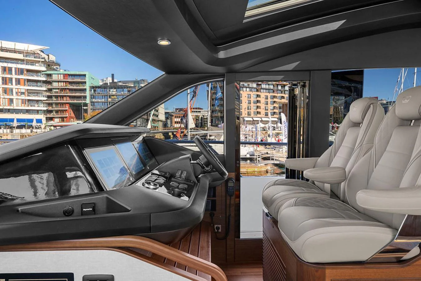 The helm station features modern navigation equipment and luxurious seating with a view of the marina. aboard PRINCESS S72 Yacht for Sale