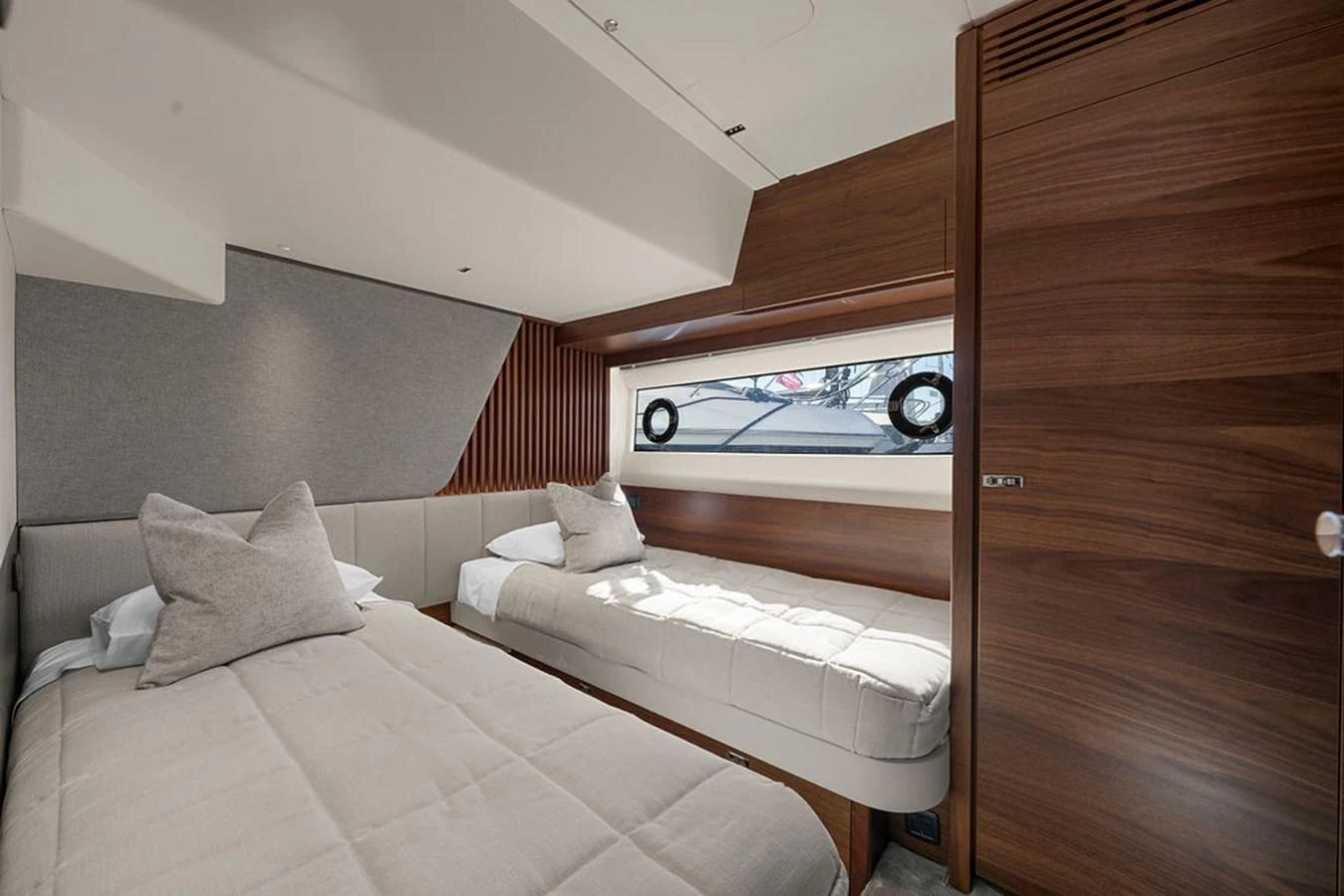 The guest stateroom features twin beds with modern wood finishes and ample natural light. aboard PRINCESS S72 Yacht for Sale