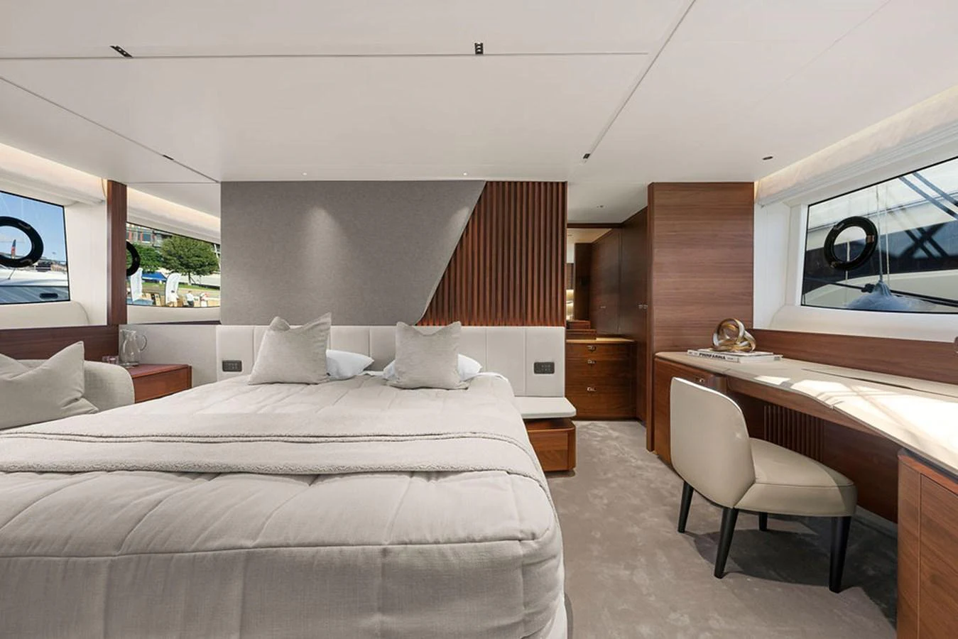 The master stateroom features a luxurious bed, elegant wood finishes, and ample natural light. aboard PRINCESS S72 Yacht for Sale