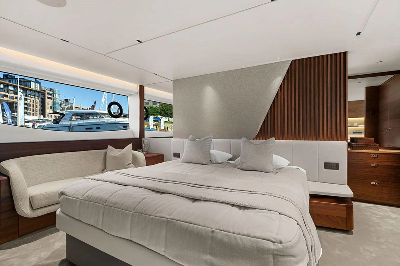 The stateroom features a luxurious bed, a cozy seating area, and elegant wood finishes. aboard PRINCESS S72 Yacht for Sale