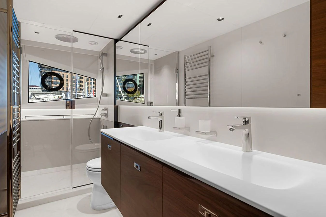 The yacht's bathroom features a modern design with dual sinks and a spacious shower area. aboard PRINCESS S72 Yacht for Sale