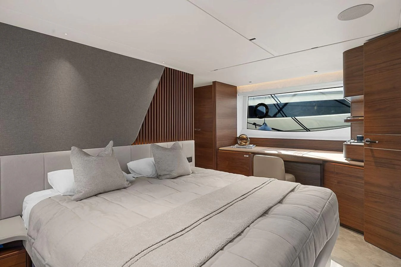 This elegant stateroom features a plush bed and a stylish desk area with a view of the sea. aboard PRINCESS S72 Yacht for Sale