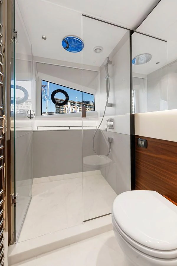 The yacht's bathroom features modern fixtures and a sleek design with a glass-enclosed shower. aboard PRINCESS S72 Yacht for Sale