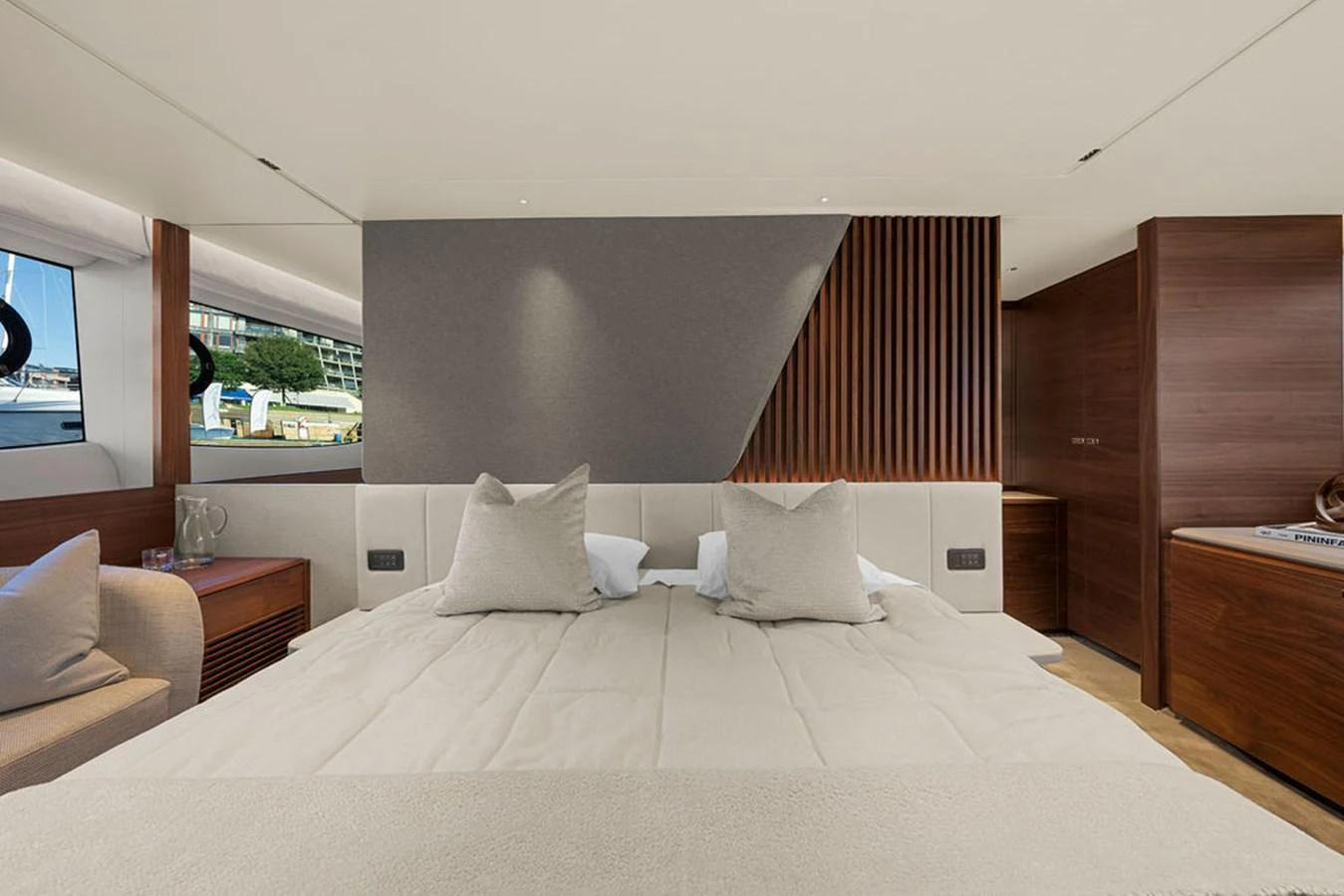 The master stateroom features a luxurious bed with plush pillows and modern wood paneling. aboard PRINCESS S72 Yacht for Sale