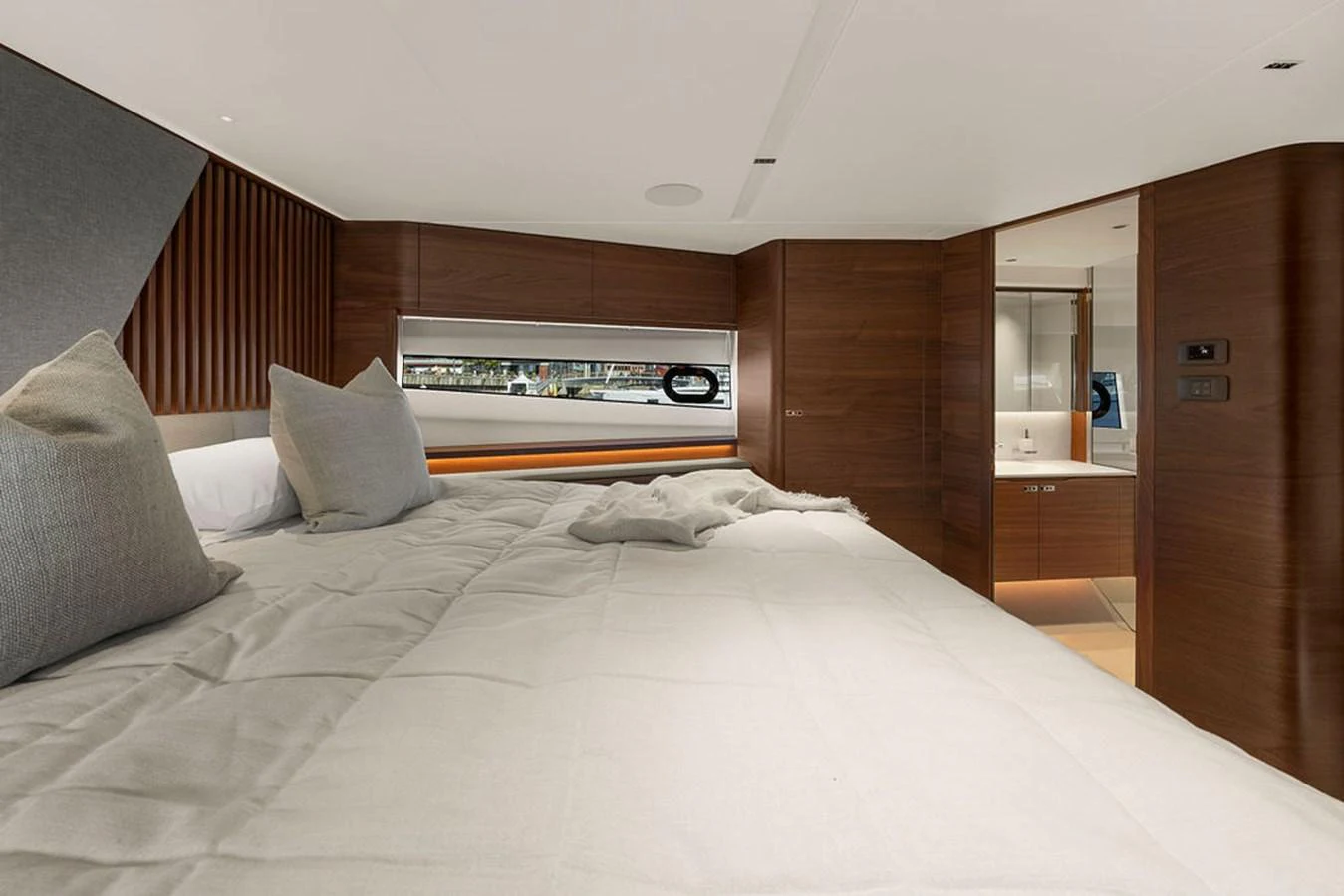 The stateroom features a luxurious bed with plush pillows and a modern, elegant design. aboard PRINCESS S72 Yacht for Sale