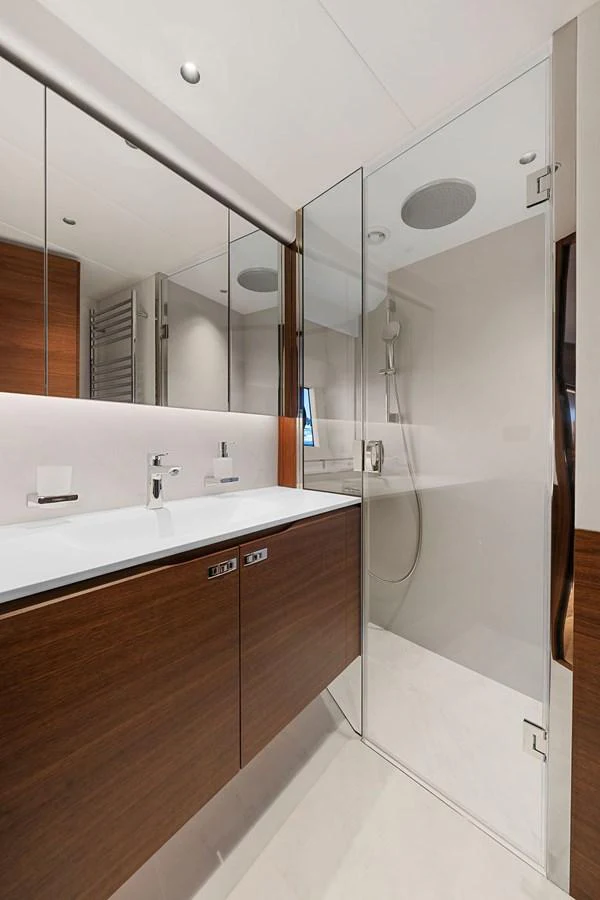 The yacht's bathroom features modern fixtures and a sleek design with a glass-enclosed shower. aboard PRINCESS S72 Yacht for Sale