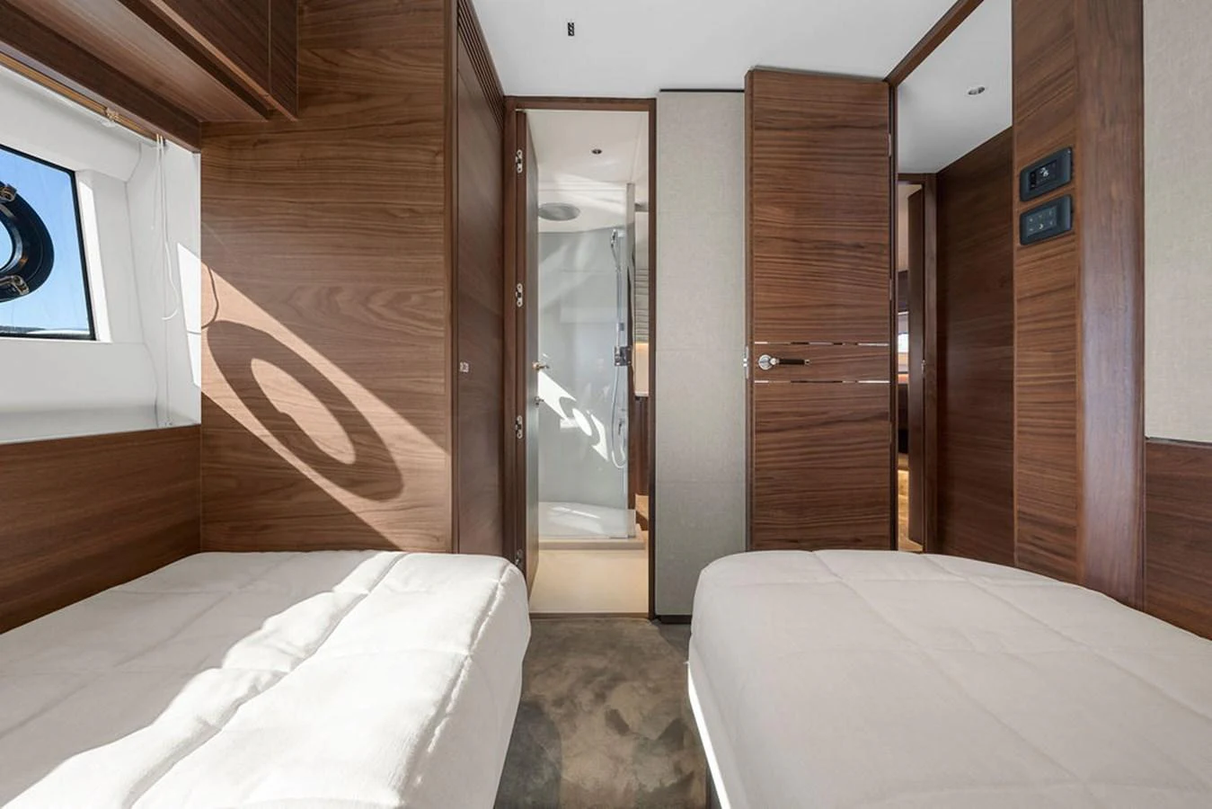 The guest stateroom features twin beds and a modern ensuite bathroom. aboard PRINCESS S72 Yacht for Sale