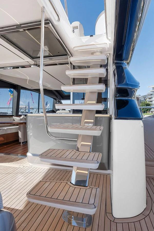 A sleek staircase with wooden steps leads to the upper deck of the yacht. aboard PRINCESS S72 Yacht for Sale