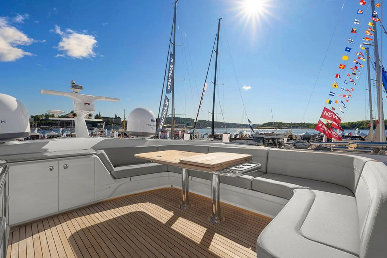 The aft deck features a spacious seating area with a wooden table, perfect for outdoor relaxation and dining. aboard PRINCESS S72 Yacht for Sale