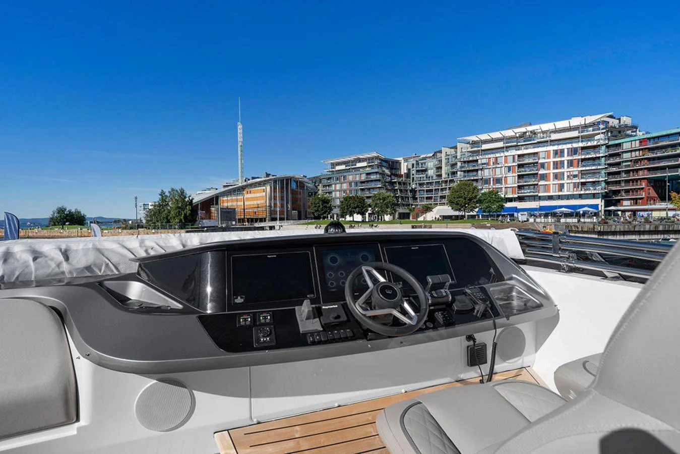 The yacht's helm offers a sleek and modern control station with a panoramic view of the marina. aboard PRINCESS S72 Yacht for Sale