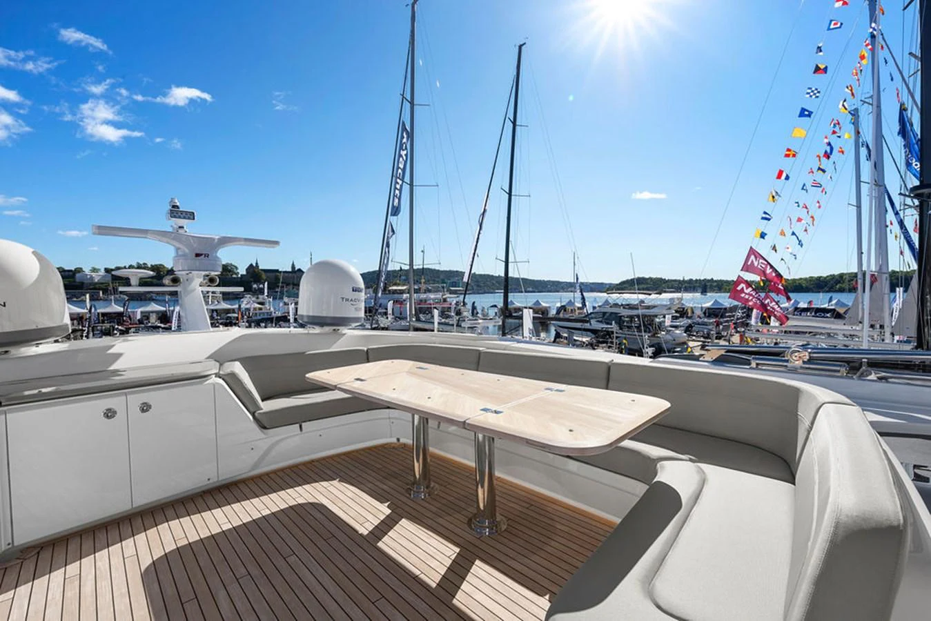 The flybridge offers a spacious seating area with a wooden table, perfect for enjoying panoramic views. aboard PRINCESS S72 Yacht for Sale