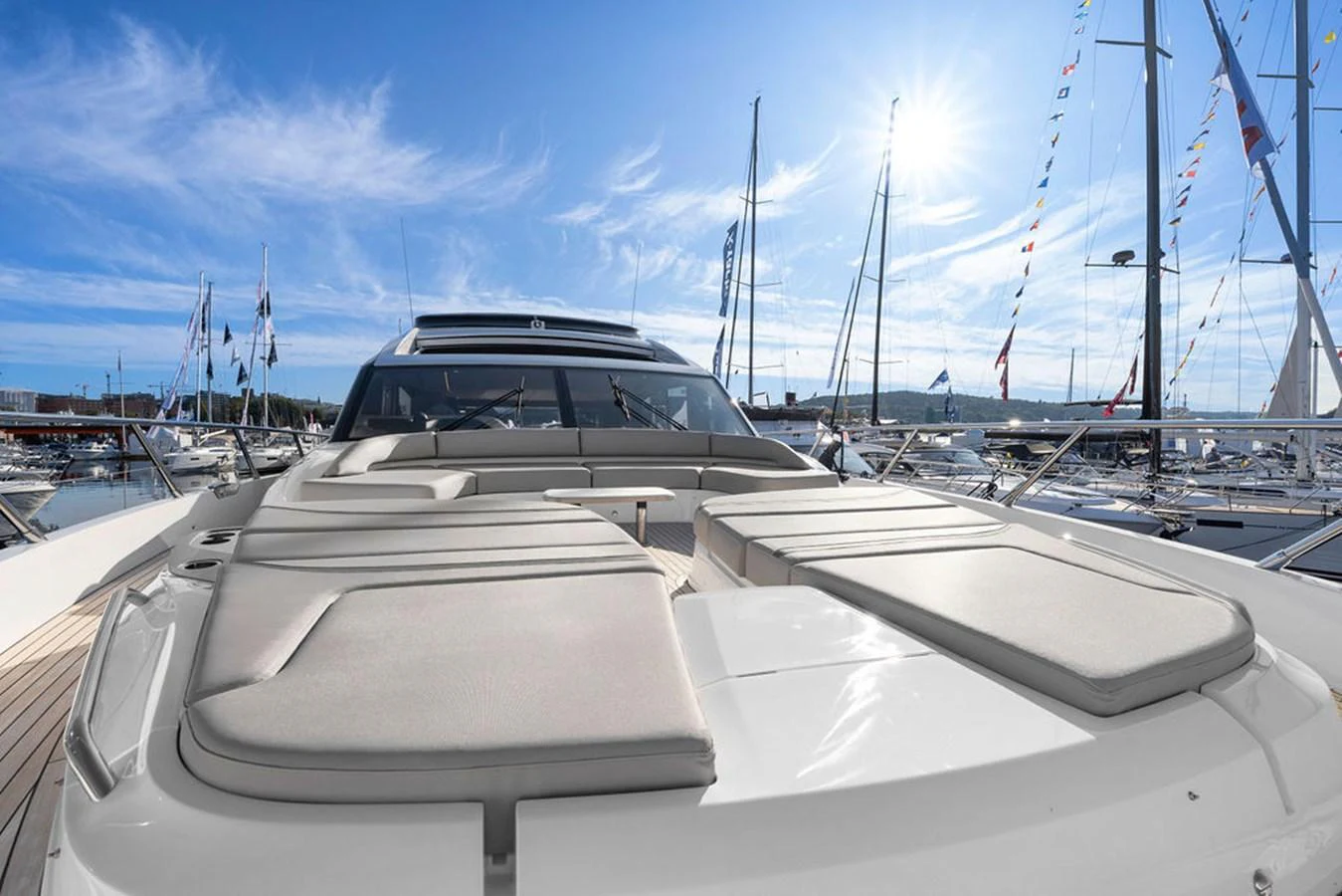 The yacht's exterior features a spacious sunbathing area with plush cushions, perfect for relaxation under the sun. aboard PRINCESS S72 Yacht for Sale