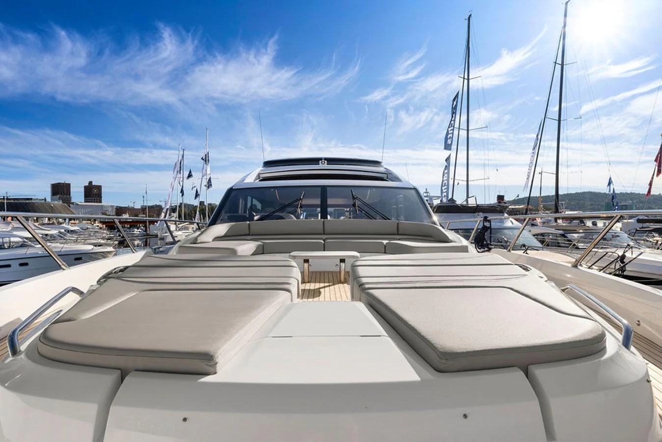 The yacht's foredeck features spacious sun pads under a clear blue sky. aboard PRINCESS S72 Yacht for Sale