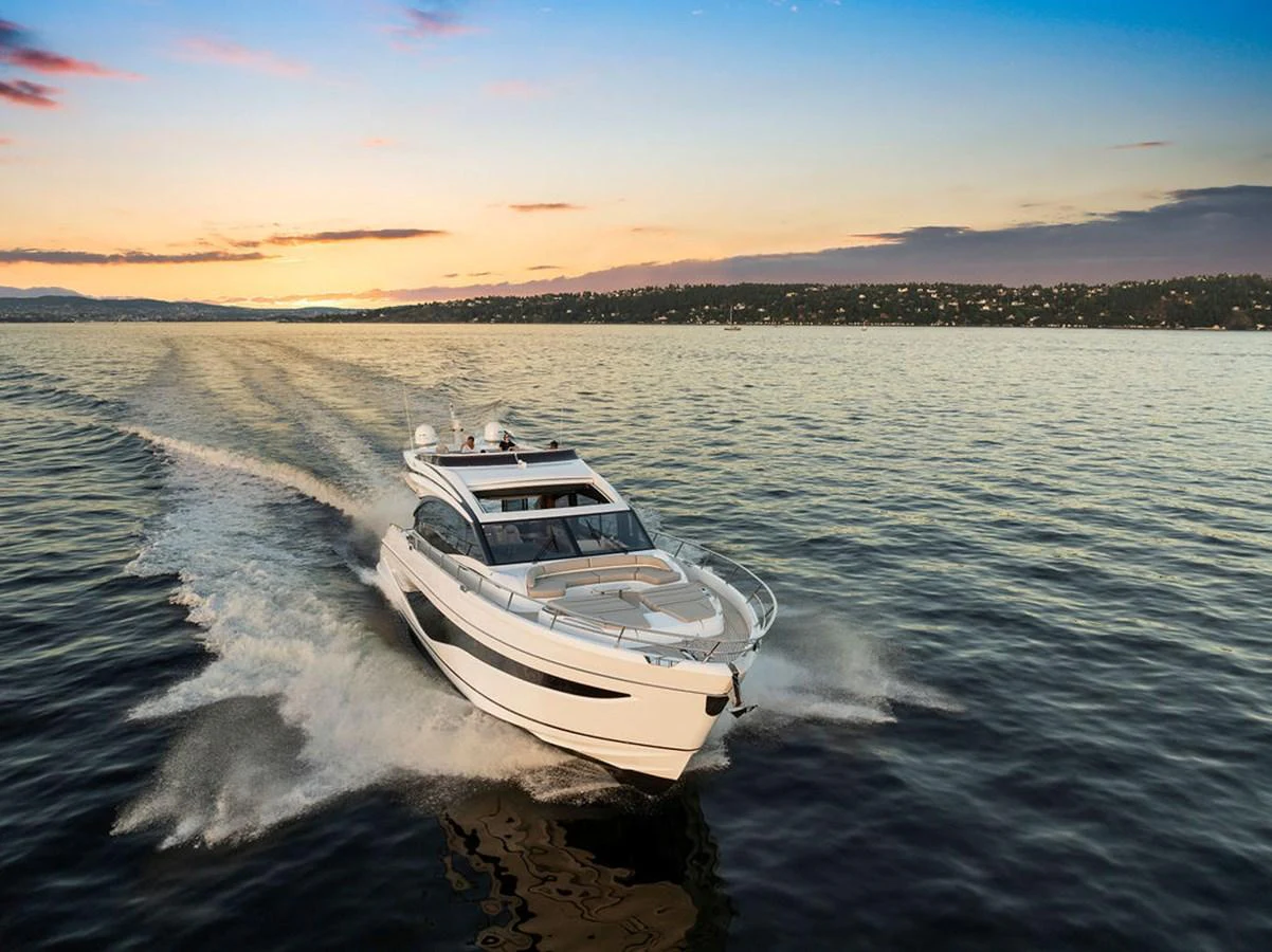 A sleek yacht cruises through calm waters at sunset, showcasing its elegant design and powerful performance. aboard PRINCESS S72 Yacht for Sale