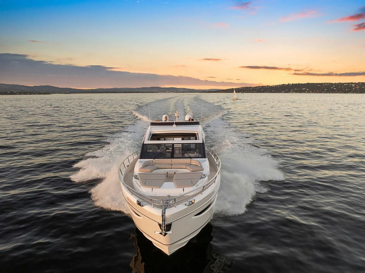 A sleek yacht cruises through calm waters at sunset, showcasing its elegant design and powerful performance. aboard PRINCESS S72 Yacht for Sale