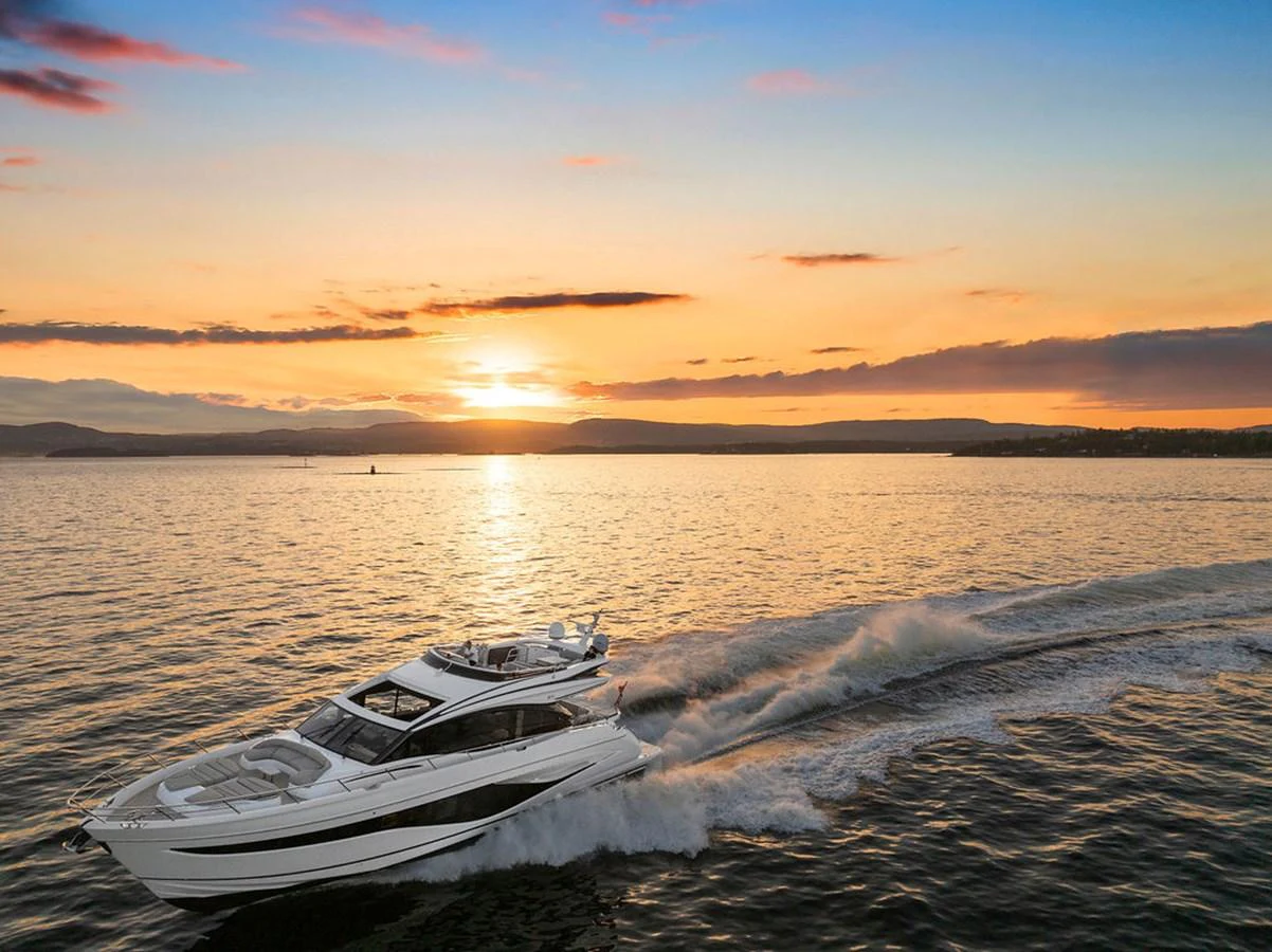 A sleek yacht cruises through calm waters at sunset, showcasing its elegant design and powerful performance. aboard PRINCESS S72 Yacht for Sale