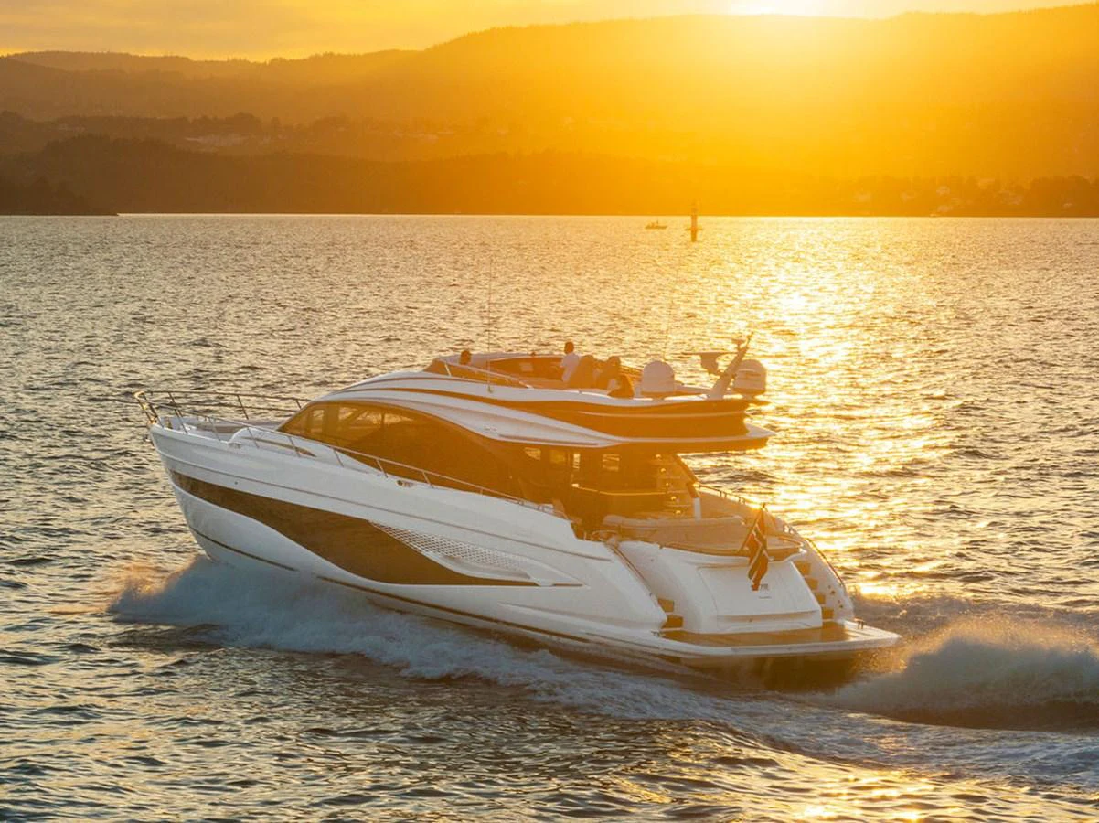 A sleek yacht cruises through the water at sunset, showcasing its elegant design and luxurious features. aboard PRINCESS S72 Yacht for Sale