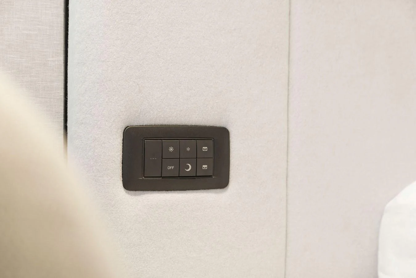 A close-up of a control panel embedded in a light-colored wall, showcasing the yacht's modern amenities. aboard PRINCESS S72 Yacht for Sale