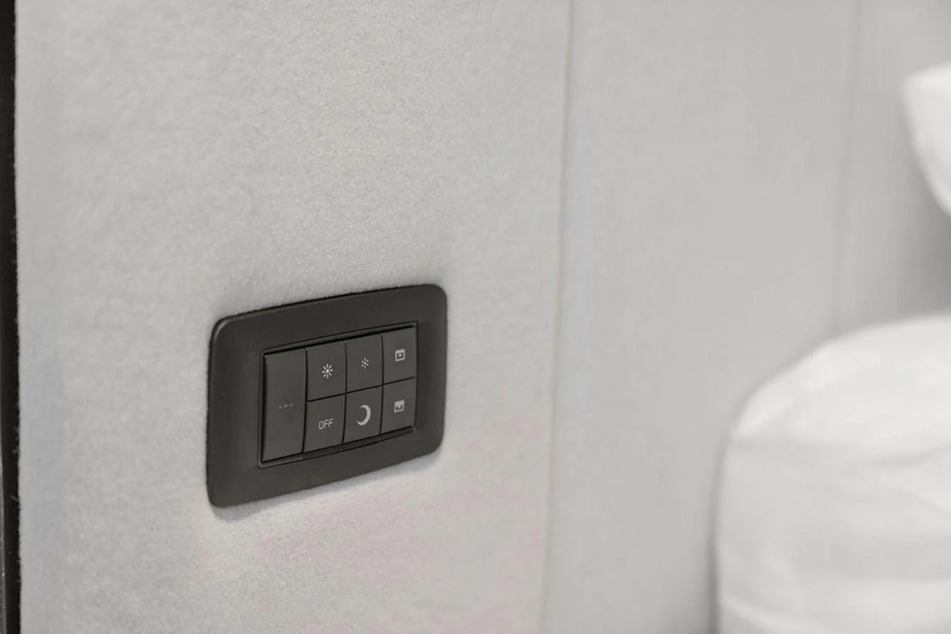 A close-up of a control panel embedded in a soft, light-colored wall, likely part of the yacht's interior. aboard PRINCESS S72 Yacht for Sale