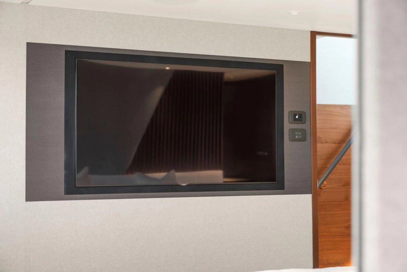 A modern interior space featuring a large flat-screen television mounted on the wall. aboard PRINCESS S72 Yacht for Sale